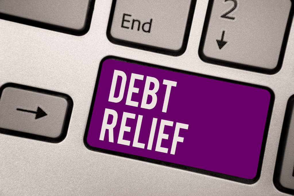 image of purple computer keyboard button showing the words debt relief