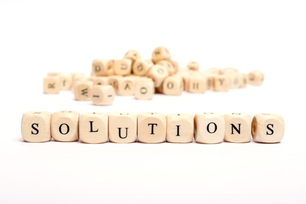 small wooden blocks spelling out the word solutions