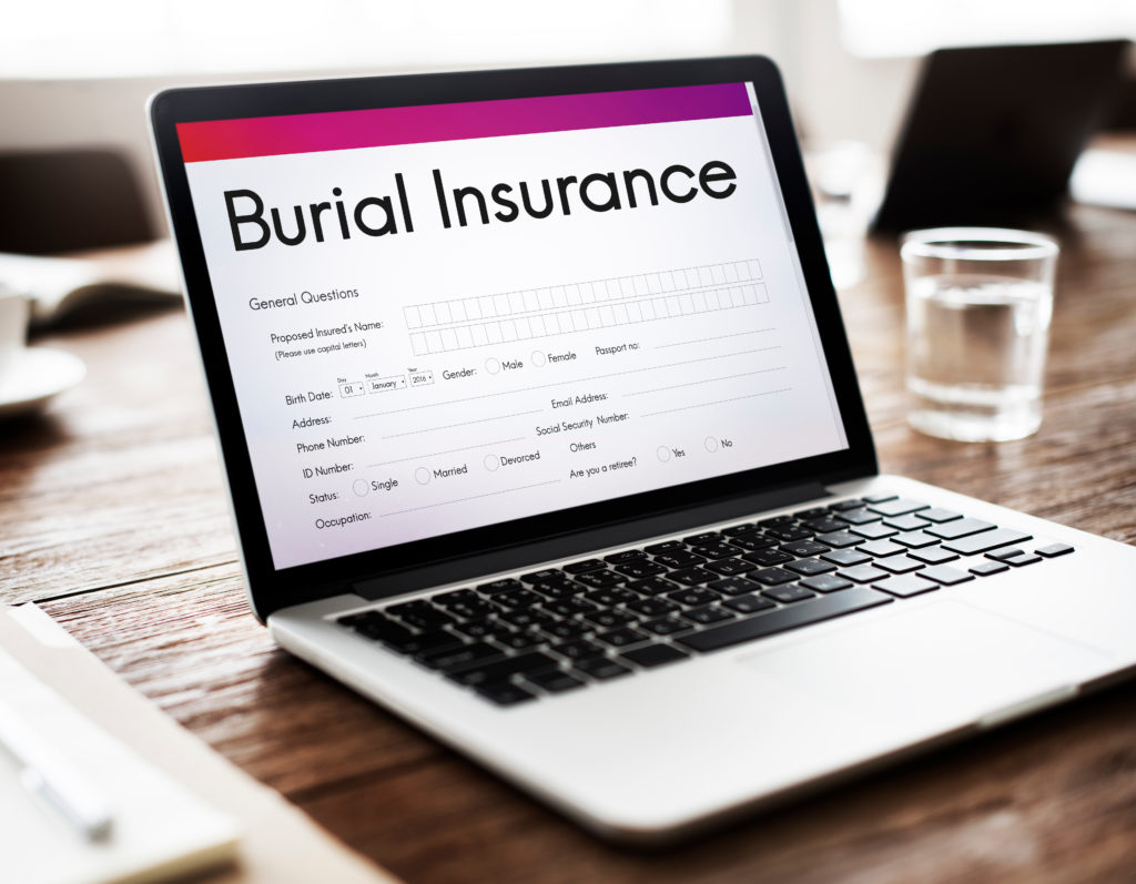 Open laptop displaying on the screen an application for burial insurance