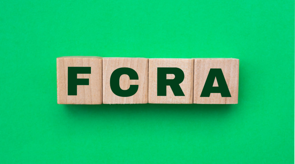 wooden blocks with the letters FCRA on a green background