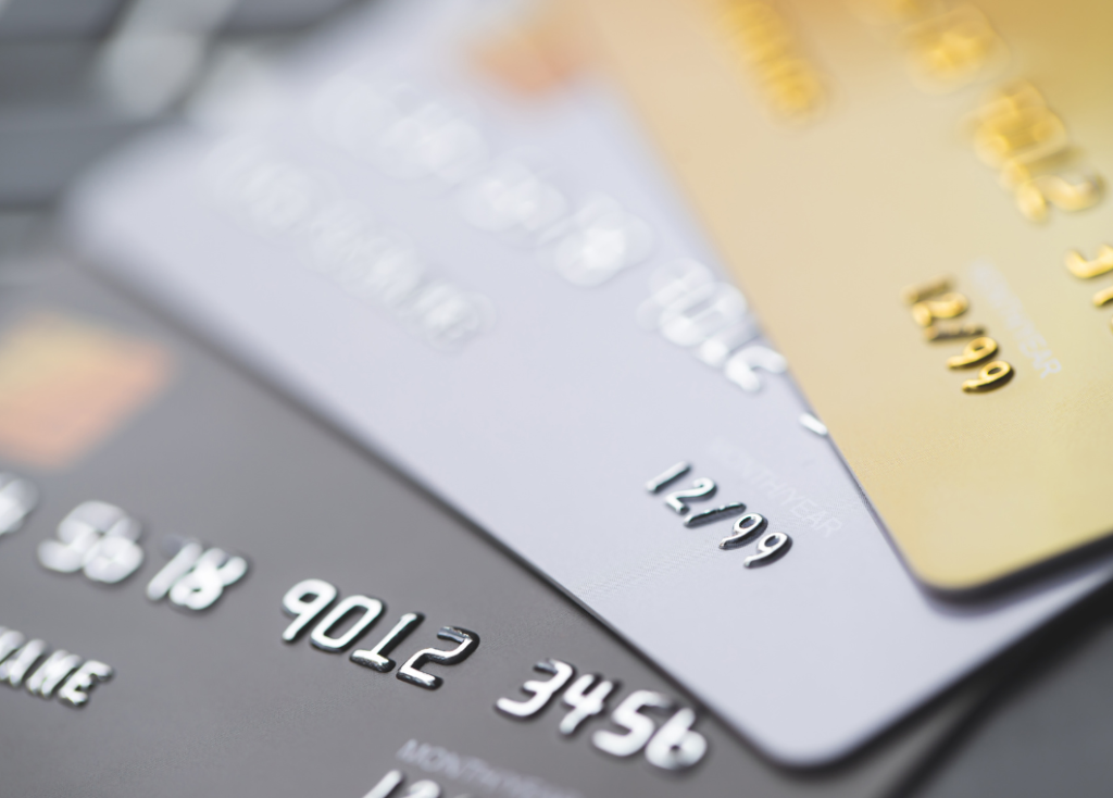 close up of three credit cards stacked on top pf each other