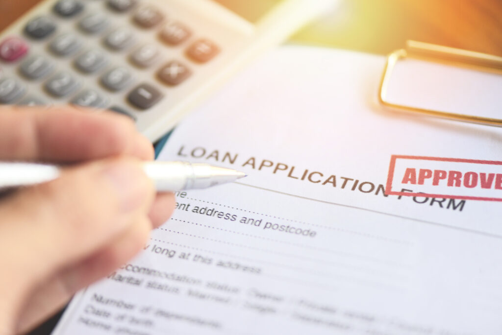 close up image of a person filling out a loan application form