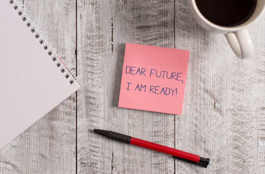 Handwriting text Dear Future I Am Ready. Stationary placed next to a cup of black coffee above the wooden table